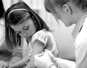 Shouldn't the after-effects of vaccinations be discussed before? Girl Vaccination pic.